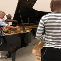 Pianist Jill Richards with dancers Thulani Chauke and Fanta Tshabalala.