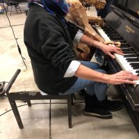 A chimp puppet, manipulated by Tony Miyambo, trying to play the piano